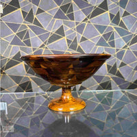 Profile view of a polished wooden bowl and stand