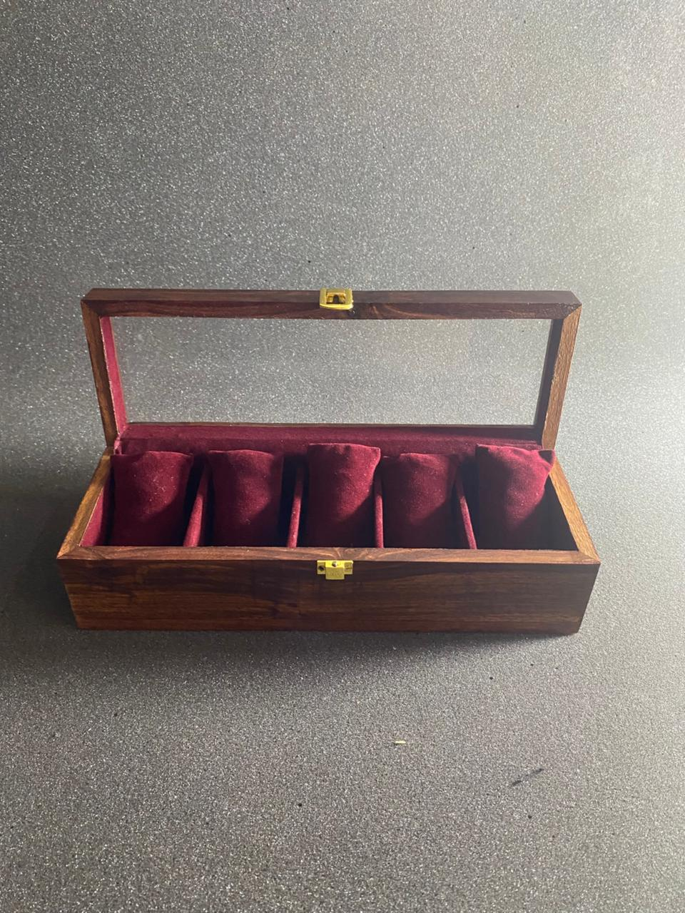 Five-slot wooden watch box with burgundy velvet pillows and glass top