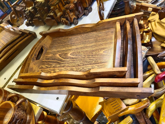 Nested wooden serving trays with raised edges and cut-out handles