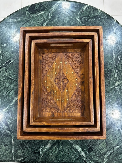 Top view of 2 nesting hand-carved wooden trays showing intricate gold inlay pattern