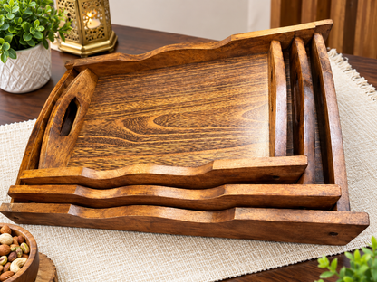 Wooden serving trays displayed stacked on a table