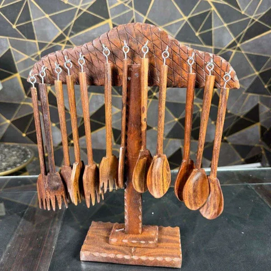 Wooden forks and spoons hanging from a decorative wooden stand