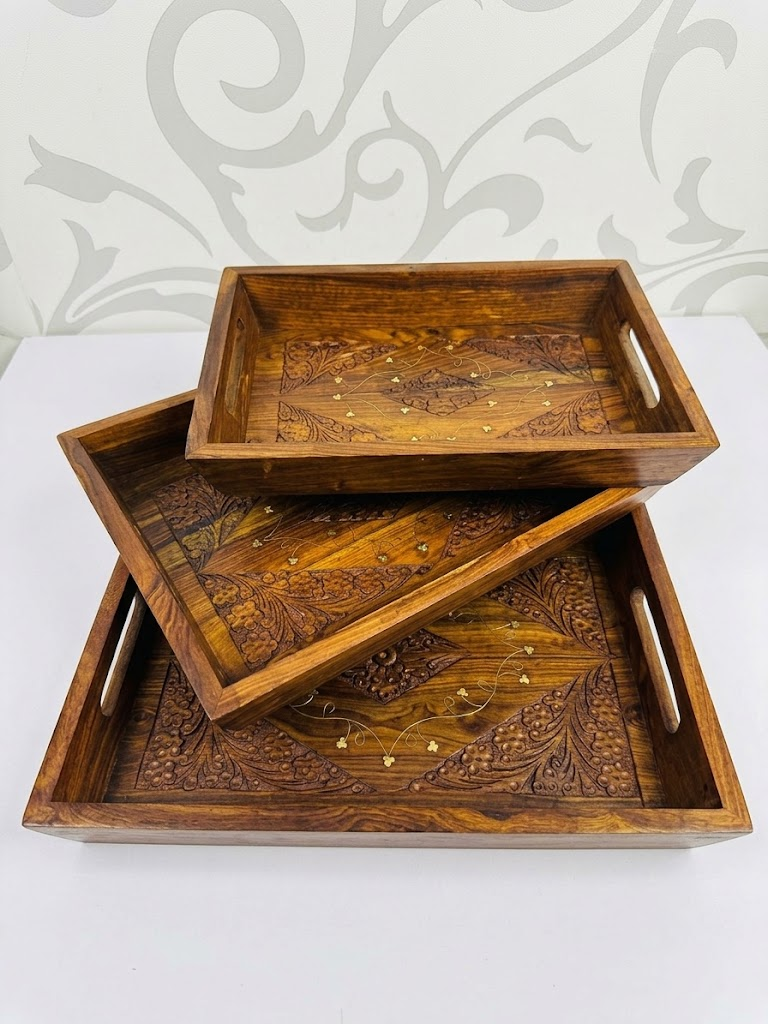 Set of 3 wooden carved trays stacked showing floral carved design