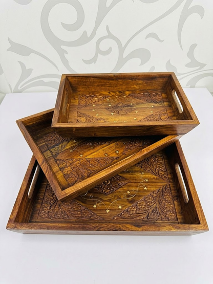 Set of 3 wooden carved trays stacked showing floral carved design